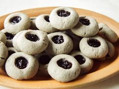 a wooden bowl filled with cookies covered in jam