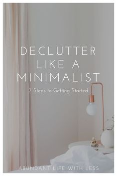 a white bed sitting next to a window with the words declutter like a minimalist