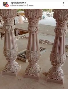 some very pretty pink pillars in the middle of a room with mirrors and other items