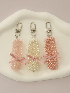 Composition : pearls, beads, ribbons, metalColor : White pearls, pink pearls, light pink crystalsCountry of Origin : Republic of Korea Acrylic Beads Crafts, Beaded Charms Patterns, Beaded Umbrella, Bead Art Projects, Bead Figures, Beaded Shoe, Beaded Wire Art, Diy Keychains, Art Vibe