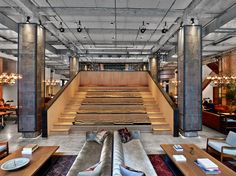 the interior of an office building with tables and stairs leading up to the second floor