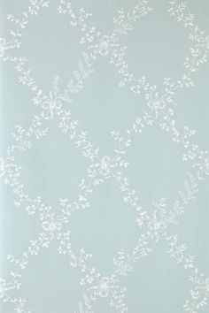 the wallpaper is white and has small leaves on it, as well as a blue background