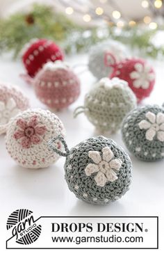 crocheted ornaments are arranged on a table with lights in the background and text overlay that says drops design