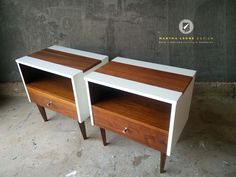 two white and wood side tables sitting next to each other