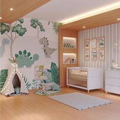 a baby's room decorated in green and white