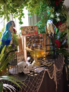 a table topped with lots of fake birds and plants