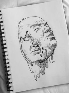 a drawing of a man's face is shown in the middle of a notebook