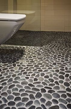 a white toilet sitting on top of a bathroom floor