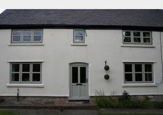 a white house with two windows and a door