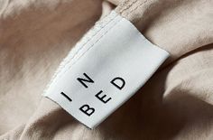 a label on the back of a shirt that says i need bed