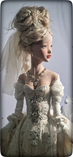 a doll wearing a wedding dress and veil