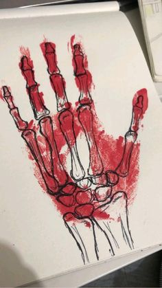 a drawing of a hand is shown on a piece of paper that has been colored red