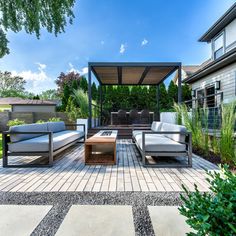 an outdoor living area with couches and tables