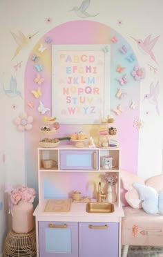 a child's playroom with pink and purple furniture, butterflies on the wall