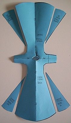 a piece of paper cut out to look like an origami fighter jet with measurements on it