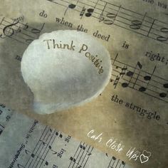 a cotton ball sitting on top of sheet music