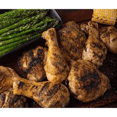 grilled chicken and asparagus with corn on the cob next to it