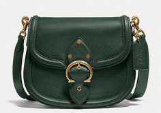 This COACH C0749 Beat Leather Saddle Crossbody Bag in Amazon Green is the perfect accessory for any woman on-the-go. Crafted from high-quality leather, it features a magnetic flap and snap closure, as well as a detachable and adjustable strap for added convenience. The bag measures 8.75\"L x 7\"H x 2.25\"D and has a 21.5\" drop strap. The bag also boasts a beautiful red sand exterior with brass gold hardware accents, including a buckle. The interior lining is also leather, adding to the bag's lu Designer Crossbody Shoulder Bag With Brass Hardware, Elegant Green Bags With Brass Hardware, Luxury Green Saddle Bag With Adjustable Strap, Green Coach Shoulder Bag With Gold-tone Hardware, Coach Crossbody Saddle Bag With Detachable Strap, Coach Green Shoulder Bag With Gold-tone Hardware, Coach Saddle Shoulder Bag With Detachable Strap, Coach Saddle Bag With Detachable Strap And Crossbody Shape, Coach Saddle Bag With Detachable Strap