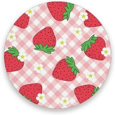 a pink and white plate with strawberries on the tablecloth pattern is featured in this image