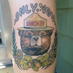 there is a tattoo on the leg of a bear that has smokey written on it