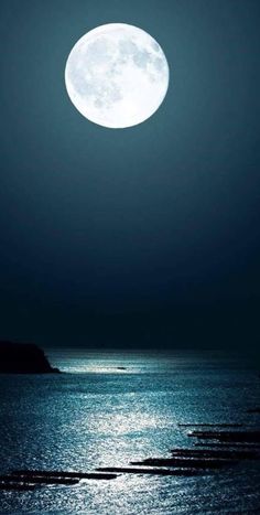 the full moon shines bright over the ocean