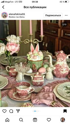 the table is set with pink and white dishes