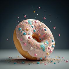 a donut with sprinkles and pink frosting on it's side