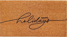 a cork door mat with the words happy holidays written on it in cursive writing