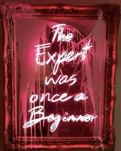 a neon sign that says the expert was once an artist