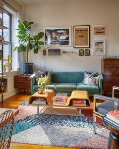 a living room filled with furniture and pictures on the wall