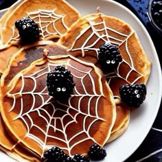 pancakes decorated with blackberries and spider webs