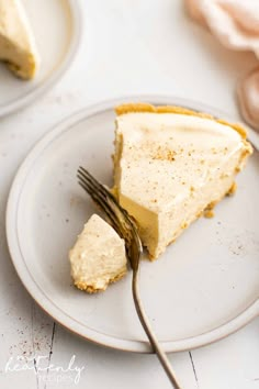 a piece of cheesecake on a plate with a fork in front of the slice