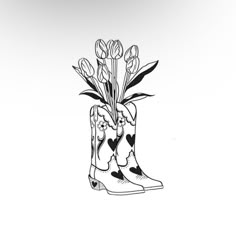 a black and white drawing of a boot with flowers in it