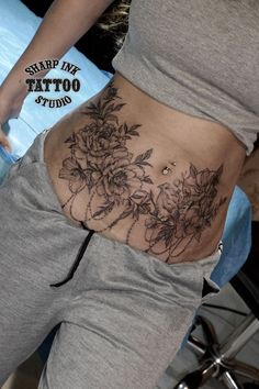 a woman's stomach with flowers on it and the bottom part of her stomach