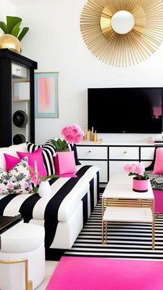 a living room with black and white furniture, pink accents, and gold accessories on the wall