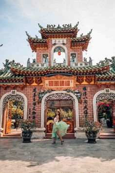 a woman is walking in front of a building