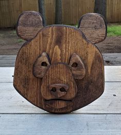 a wooden bear head on top of a table