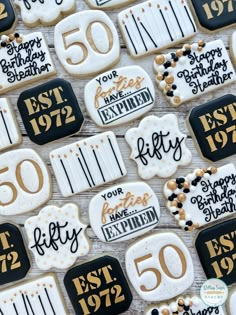 50th birthday cookies decorated with black and white icing are on display for guests to enjoy