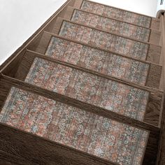 an old carpeted stair case on the side of a tall building with a clock tower in the background