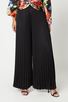 Introducing our All Over Pleated Wide Leg Trousers, a stylish addition to your wardrobe. These trousers feature a flattering wide leg silhouette that elongates the legs and provides a comfortable fit. The all-over pleated design adds a touch of sophistication and texture to your outfit, making it perfect for both casual and formal occasions. Made from high-quality materials, these trousers are durable and easy to care for Black Pleated Wide Leg Pants, Pleated Palazzo Pants Outfits, Black Plazo, Plazo Design, Pleated Palazzo Pants, Palazzo Pants Outfit, Evening Trousers, Chic Dress Classy, Black Wide Leg Trousers