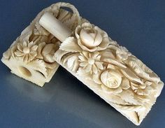 two carved soap bars sitting on top of a table