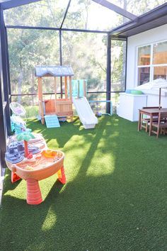 an outdoor play area with toys and slides for children to play on in the back yard