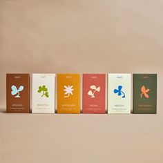 five different types of chocolates are lined up in a row on a beige background