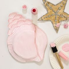 paper plates and other crafting supplies on a white surface with a star shaped ornament in the background