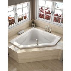 a large jacuzzi tub in the corner of a bathroom with windows and candles