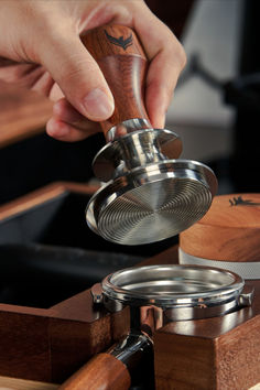 a person is using a grinder to cut something out of wood with a knife