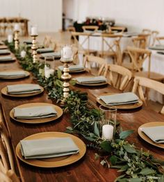 the table is set with plates and place settings for an elegant dinner or reception party