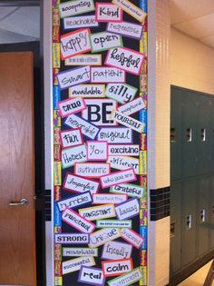 a large poster with words written in different languages on the side of a wall next to lockers