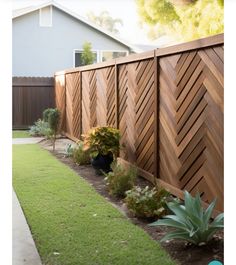 a wooden fence next to a lush green yard