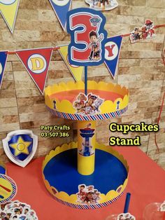 a cupcake stand with decorations on it for birthdays and other special occasiones